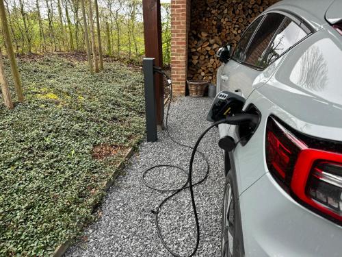 a car is hooked up to a electric car charger at La Coline in Somme-Leuze