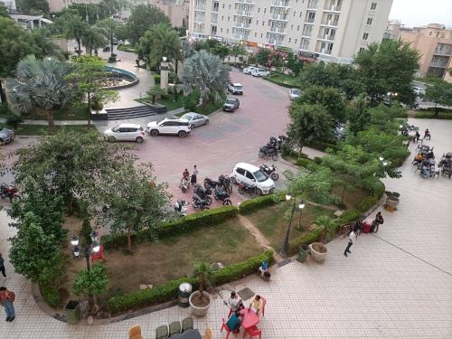 an aerial view of a parking lot with cars and people at Mero vrindavan home stay in Chhatikara