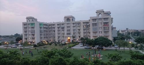 a large building with a park in front of it at Mero vrindavan home stay in Chhatikara