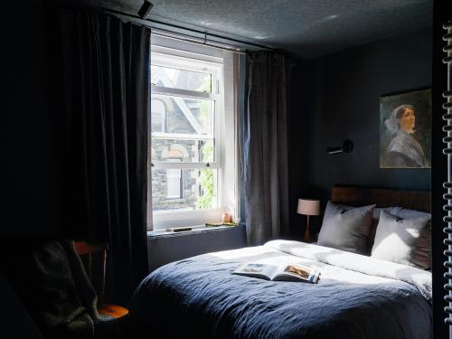a bedroom with a bed and a window at Cambridge House in Windermere
