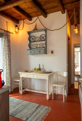a kitchen with a table and chairs in a room at Nefeli in Livadion