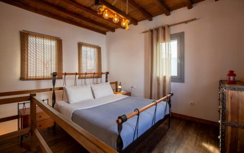 a bedroom with a bed in a room with wooden floors at Nefeli in Livadion