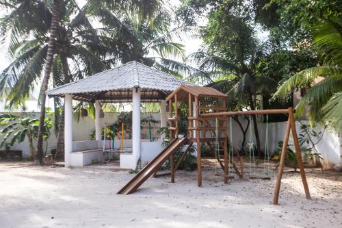 a playground in front of a gazebo at Pousada Vila Flow in Cumbuco