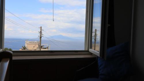 a window with a view of a mountain at Cataldo Guest House in Capri