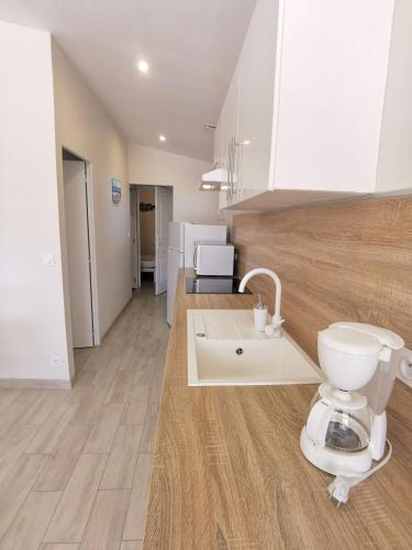 La salle de bains est pourvue de toilettes au milieu de la cuisine. dans l'établissement Villa avec son Lodge - Piscine Lagune - 10 personnes, à Linxe