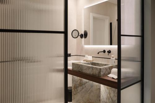 a bathroom with a sink and a mirror at Emme Palace Hotel & Spa in Orvieto