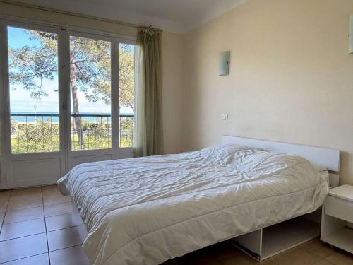 une chambre avec un lit et une grande fenêtre dans l'établissement Appartement 2 pièces, 3 couchages, centre-ville, proche mer - FR-1-225-372, à Argelès-sur-Mer