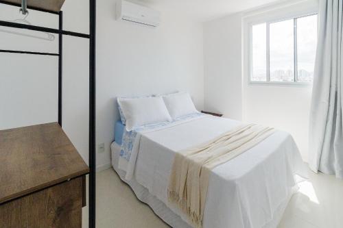 En eller flere senge i et værelse på Varanda Rede Vista Mar 8 Andar • Ed Palmer • NOMDS