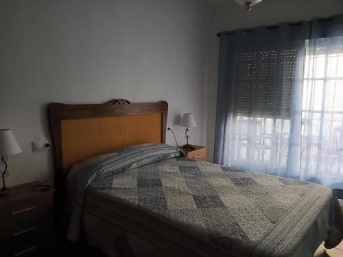 a bedroom with a bed and a window at Charming Villa in Punta Umbría with Private Pool in Punta Umbría