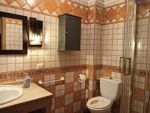 a bathroom with a toilet and a sink at Charming Villa in Punta Umbría with Private Pool in Punta Umbría