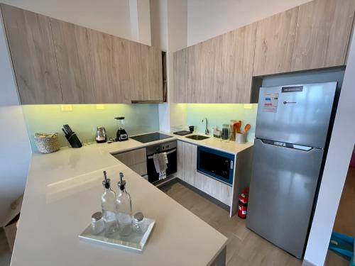 a kitchen with a white counter and a refrigerator at HOM I Duplex en Mejor Vista de Valparaiso y Parking in Valparaíso