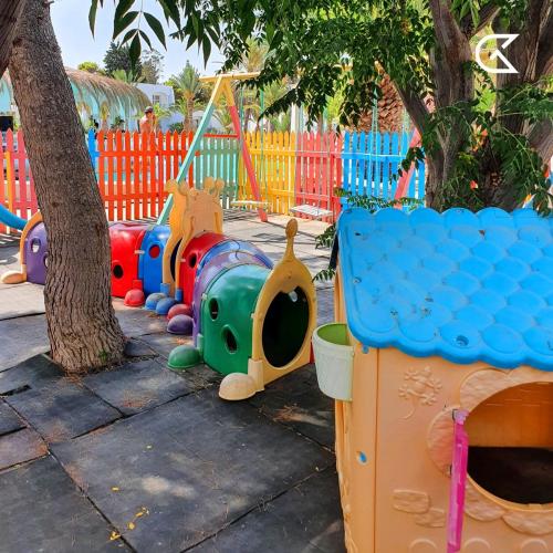 a playground with colorful play equipment in a park at Golden Tulip Président Hammamet in Hammamet