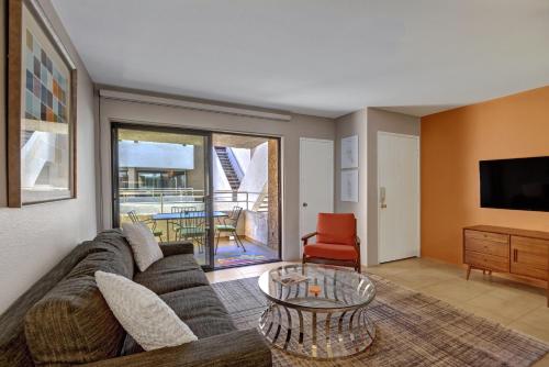a living room with a couch and a table at Biarritz Getaway - 1br condo downtown PS in Palm Springs