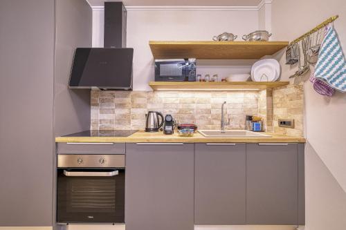 a small kitchen with white cabinets and a sink at Nafplia Castle in Nafplio