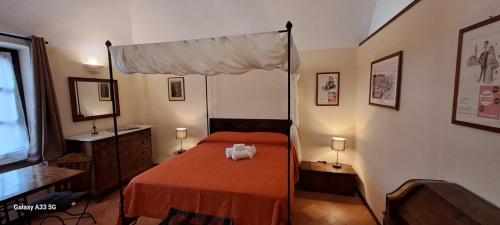 a bedroom with a red bed with a canopy at Oryza Guest House in Desana