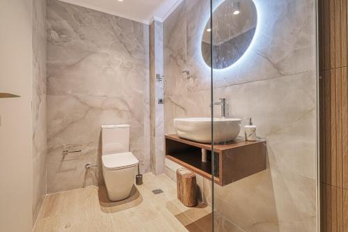 a bathroom with a white toilet and a sink at Nafplia Castle in Nafplio