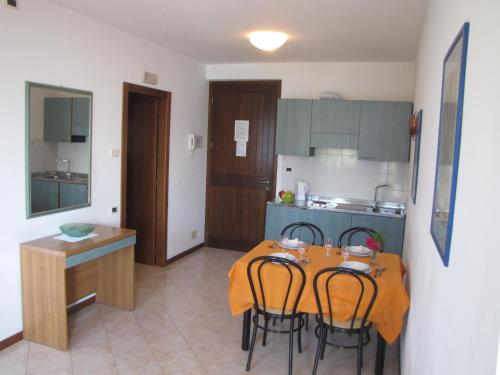 a kitchen with a table and chairs in a kitchen at Residence Villa Margherita in Brenzone sul Garda