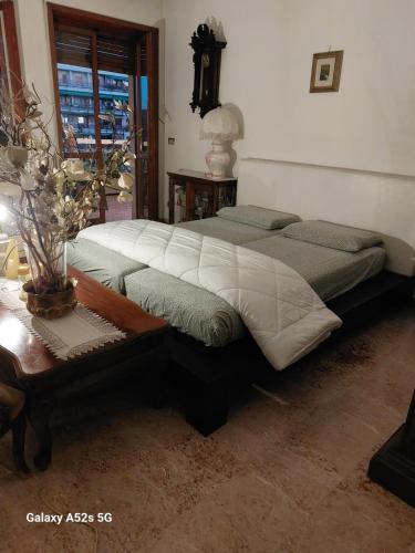 a bedroom with two beds and a table and a window at PUNTO FM Venezia in Venice