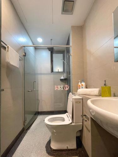 a bathroom with a toilet and a sink and a shower at Ezyhouz - IMAGO The Loft in Kota Kinabalu