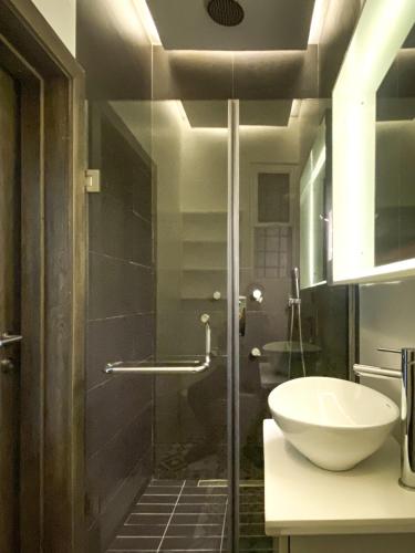 a bathroom with a sink and a glass shower at Zen Studio Apt Lekki 1 in Ilado