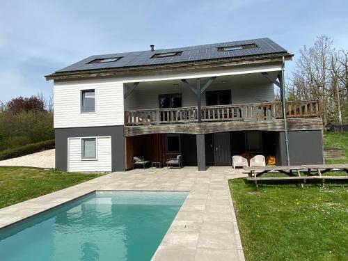 a house with a deck and a swimming pool at Le Bercail in Somme-Leuze