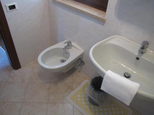 a bathroom with a sink and a toilet and a bidet at Residence Villa Margherita in Brenzone sul Garda
