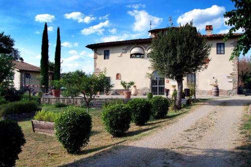 a large white house with trees and bushes at Agriturismo il Pino - Bioagricoltura in Monticello