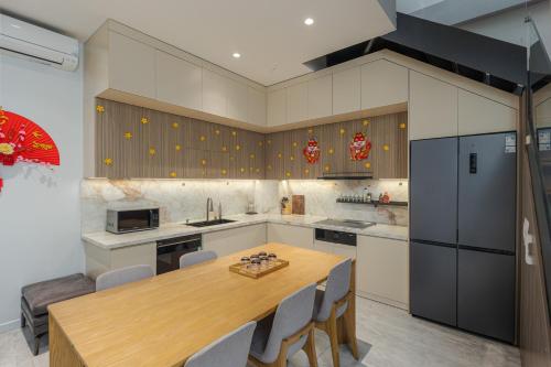a large kitchen with a wooden table and chairs at Thảo Nguyên Homestay in Hanoi