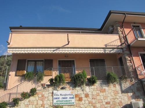 a building with a balcony with plants on it at Residence Villa Margherita in Brenzone sul Garda