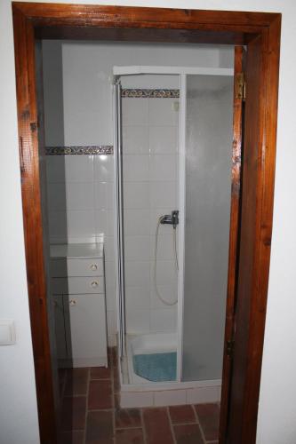 a bathroom with a shower with a glass door at Casa da Timenina Privates Rooms in São Brás de Alportel