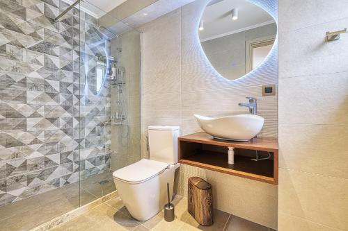 a bathroom with a sink and a toilet and a mirror at Nafplia Castle in Nafplio