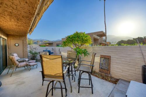 a patio with chairs and a table and a fireplace at Villas de Las Flores Serena in Palm Springs