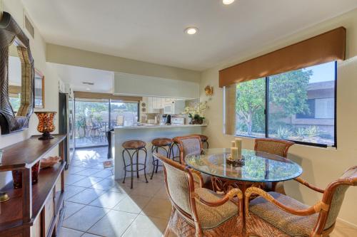 a kitchen and dining room with a table and chairs at Villas de Las Flores Serena in Palm Springs