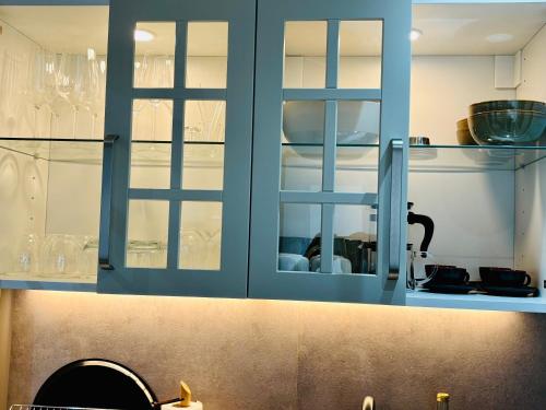 una cucina con mobili blu e un lavandino di MoonDayHomes - TopLocation I 4Persons I Gallery Maisonette Boutique Apartment PERA a Francoforte sul Meno