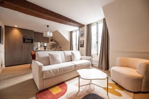 - un salon avec un canapé blanc et une chaise dans l'établissement vivez au coeur du Marais, à Paris