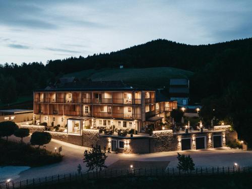 a large building with lights in front of it at Hotel Muhr in Pöllauberg