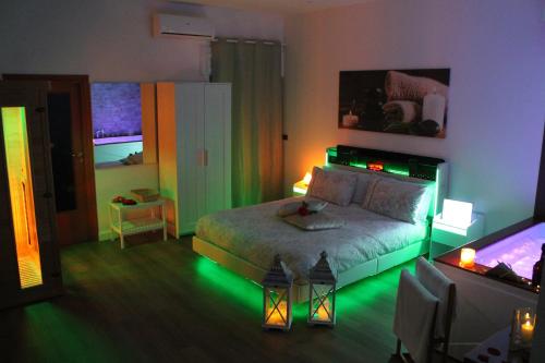 a bedroom with a bed with green lights on it at Residenza Noè in Antica Villa - Suite & Spa in Fisciano
