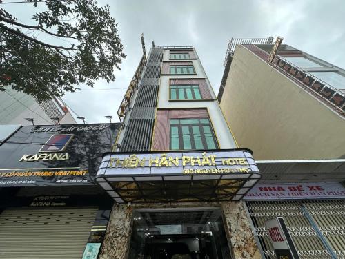 a tall building with a sign in front of it at Thien Han Phat Hotel in Da Nang