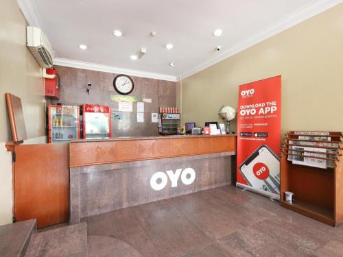 a waiting area of a ovo store with a clock at Super OYO 447 Comfort Hotel Meru in Klang