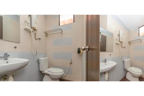 a bathroom with two sinks and two toilets at Skudai Hotel in Skudai
