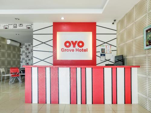 a lobby with a red and white stripe wall at OYO 89583 Grove Hotel in Kajang