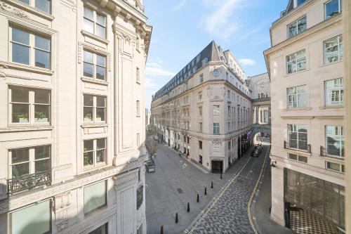 a view of a street between two buildings at Prime Soho 3-Bedroom Apartment Steps from Piccadilly and Chinatown! No Lift 3GH in London