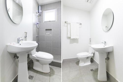 a bathroom with a sink and a toilet and a mirror at OYO 152 Sangco Condotel in Manila
