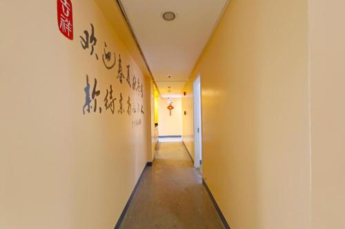 a hallway in an office building with graffiti on the wall at Loveness Apartelle in Manila