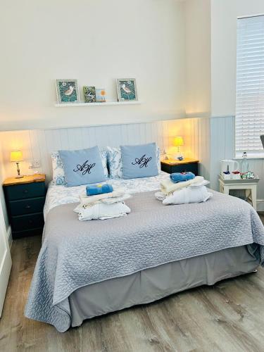 a bedroom with a large bed with towels on it at Arden House in Arundel