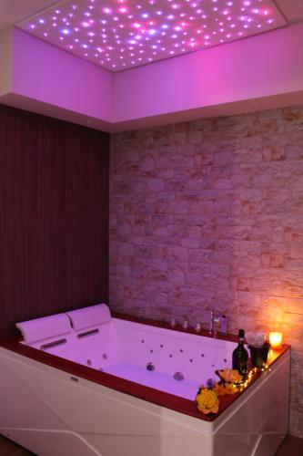 a bath tub with lights on the ceiling at Residenza Noè in Antica Villa - Suite & Spa in Fisciano