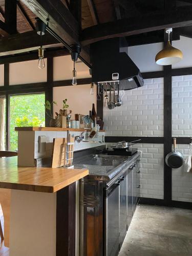a kitchen with a sink and a stove top oven at Habuman Okinawa in Kunigami
