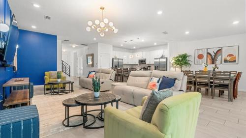 a living room with couches and a dining room at Upstay Family Home w Pool, Cinema & Games Room in Kissimmee