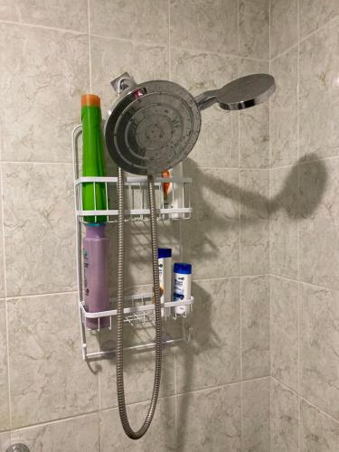 a shower head with a hose hanging on a wall at Lagoon Sunset view entire apartment in Cancún
