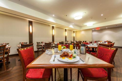 a dining room with a table with a plate of food at Holiday Inn Laval Montreal by IHG in Laval